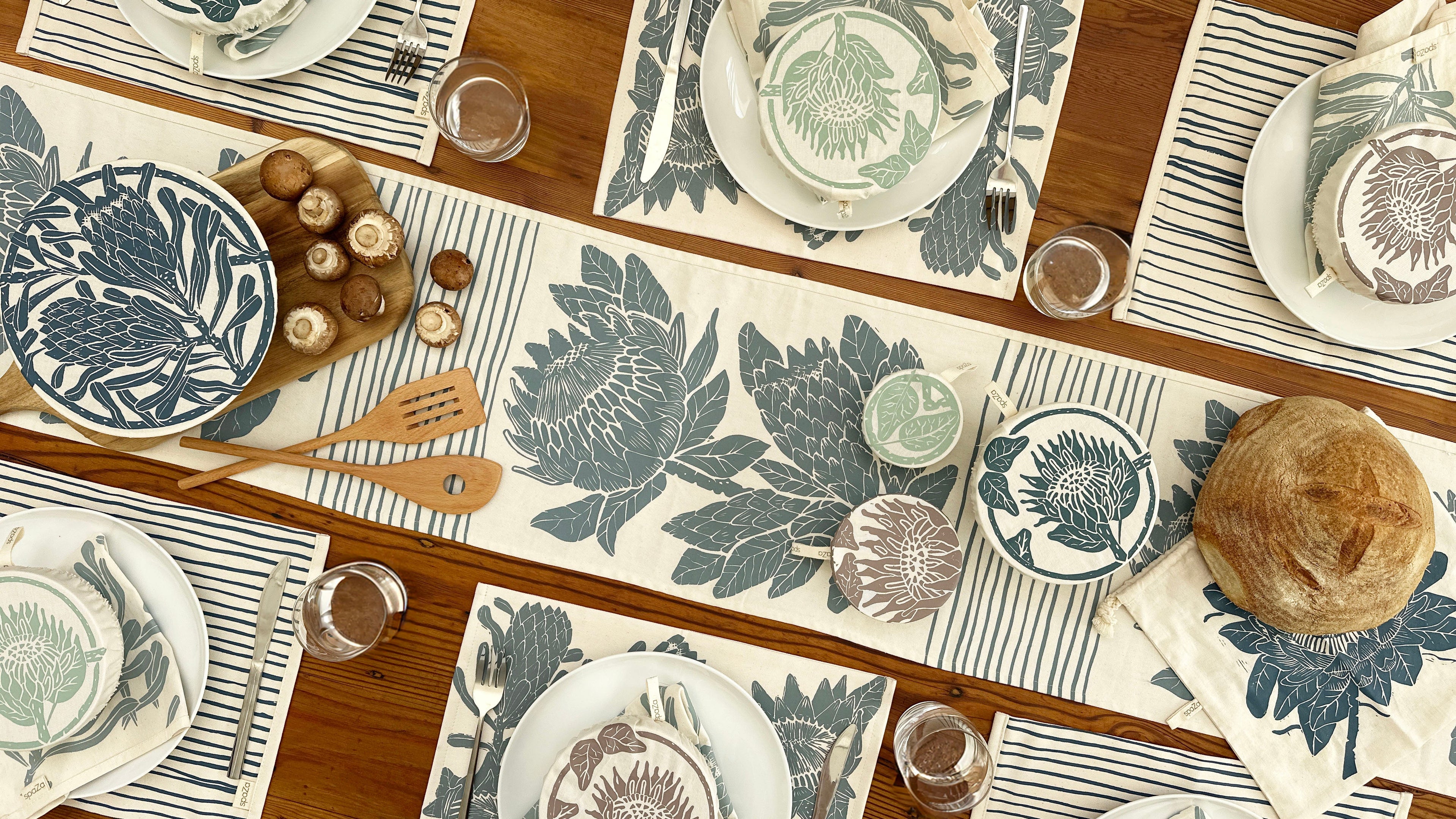 Protea Table setting with matching placemats and plates on a wooden table